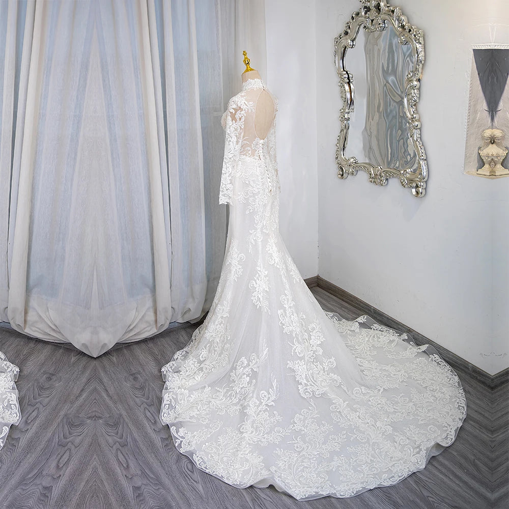 Ivory lace high-neck long-sleeve bridal gown with sweeping floor-length train