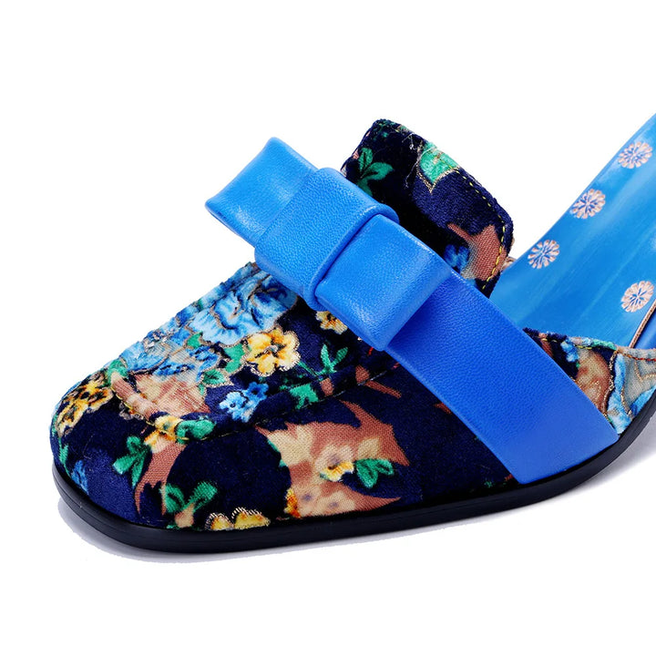 Blue floral slide high-heel sandal with wide bow strap and curved toe cap