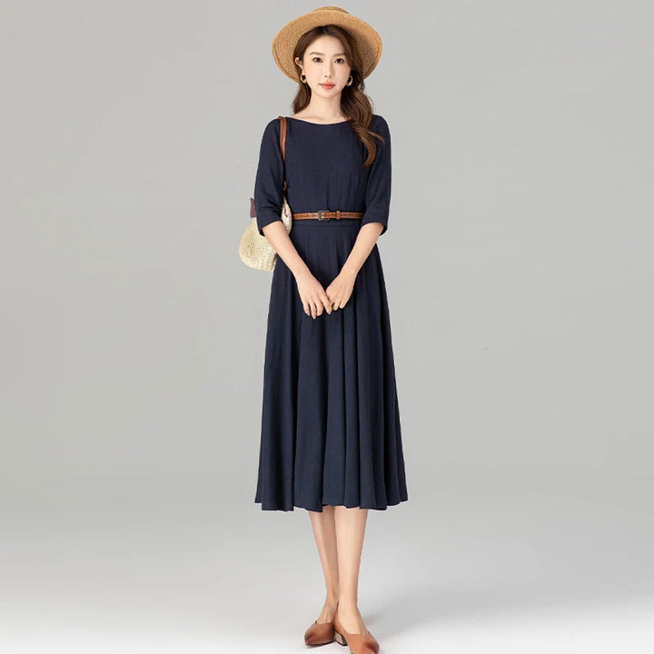 Dark blue midi dress with 3/4 sleeves, fitted waist, and pleated A-line skirt