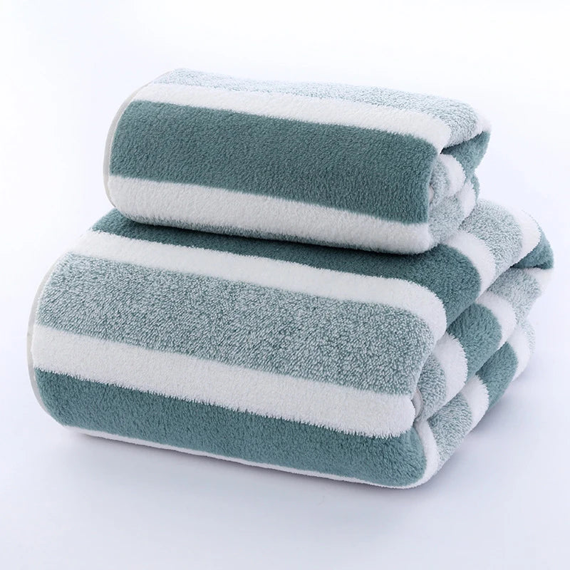 Folded green-and-white striped terry towel set, two towels stacked