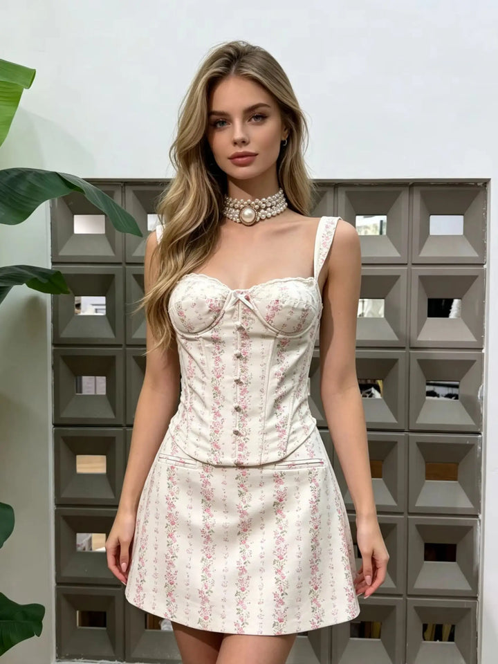 Model wearing pink floral mini skirt set with corset bodice and lace-up front
