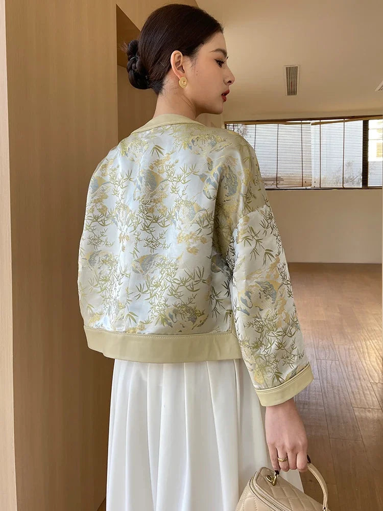 Women’s creamy yellow botanical print silk-leather coat, back view with ribbed cuffs