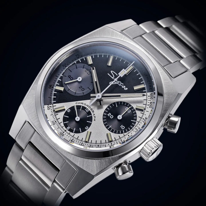 Silver metal chronograph watch with dark dial and three subdials, bracelet band