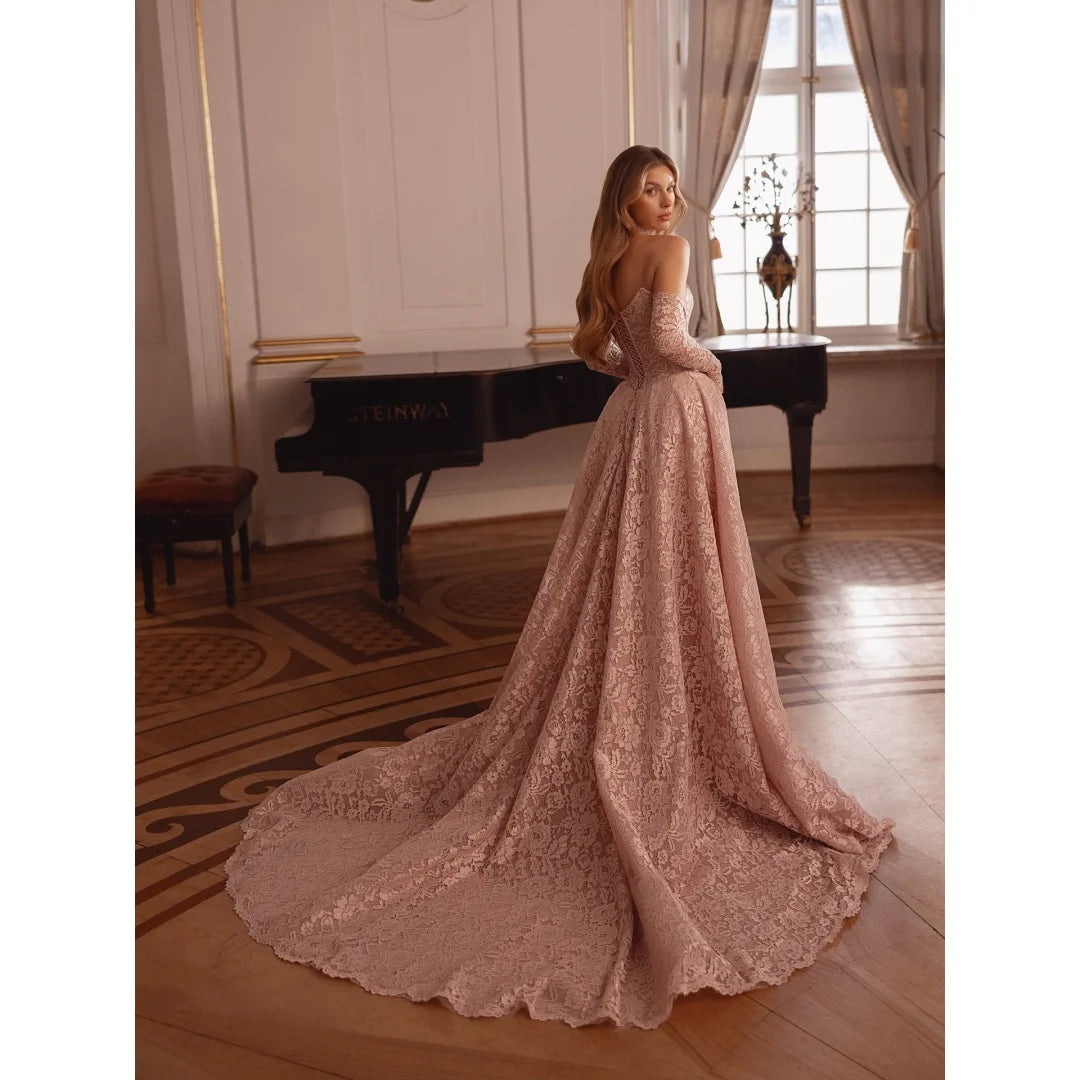 Light pink embroidered lace prom gown with fitted bodice and flowing full skirt