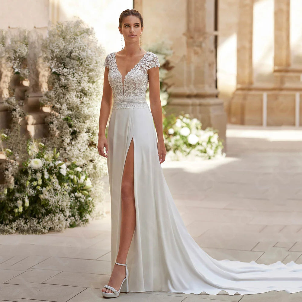 Ivory lace bridal gown with cap sleeves, deep V-neck, and thigh slit