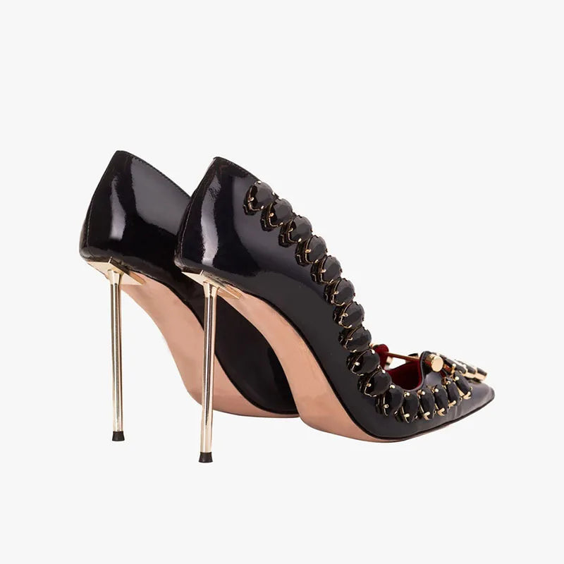 Black crystal heel pumps showing glossy heel and pointed-toe strap detail