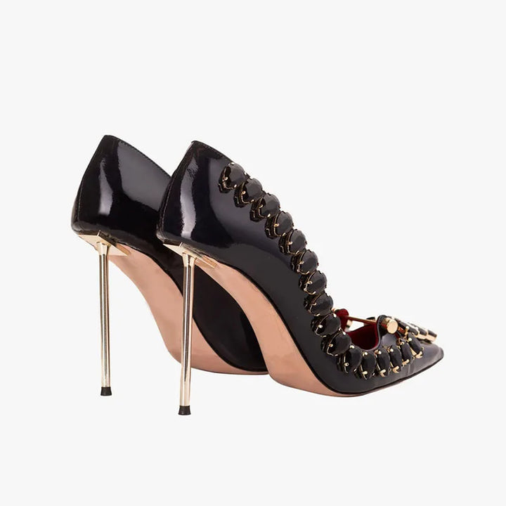 Black crystal heel pumps showing glossy heel and pointed-toe strap detail