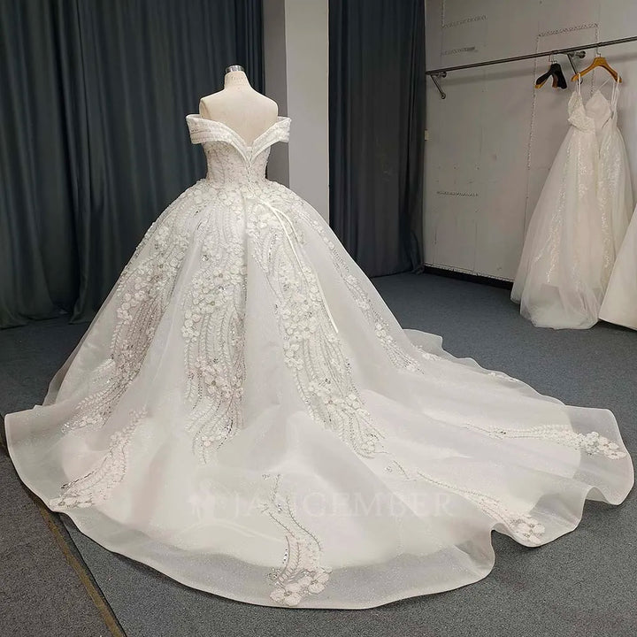 White lace bride dress on mannequin, fitted bodice with beaded floral detailing