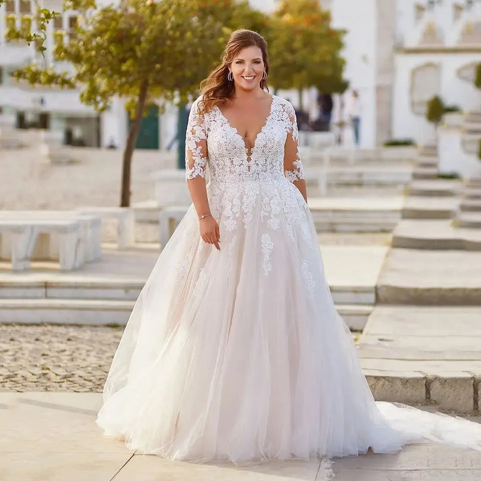 Ivory lace bridal gown with short sleeves, V-neck bodice, and full tulle skirt