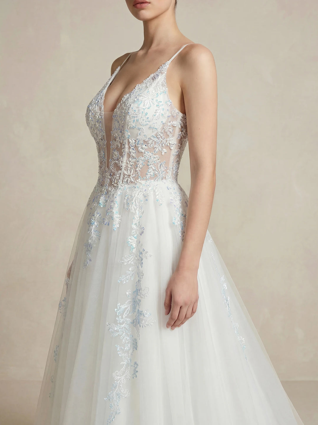 White lace embroidered bridal dress with deep V neckline and delicate lace appliques
