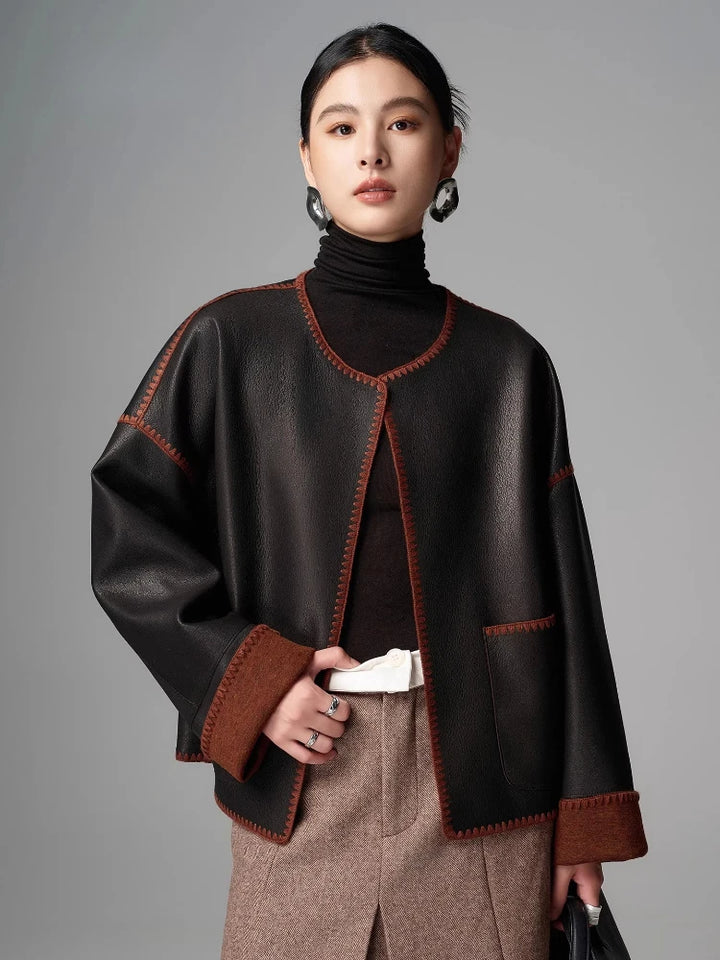 Women’s black goatskin short jacket with brown trim and orange contrast topstitching