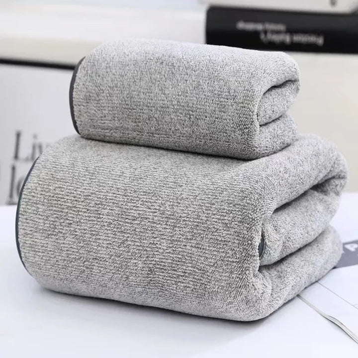Light gray heather towel set, two folded towels stacked with plush texture