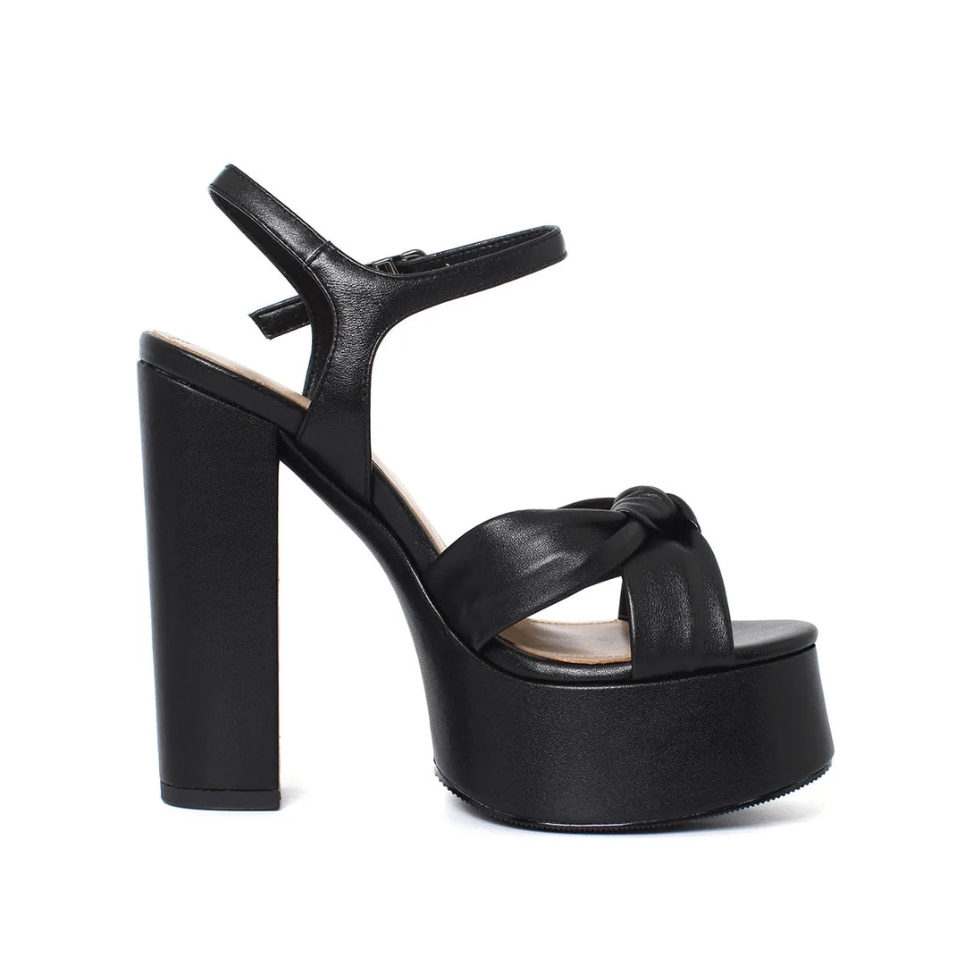 Black heeled sandal with round toe, T-strap, and platform sole