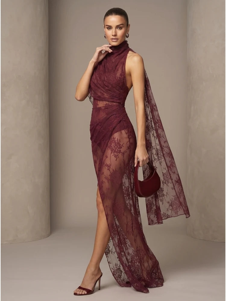 Burgundy sheer lace maxi gown with high neck, fitted bodice, sheer cape overlay, slit.
