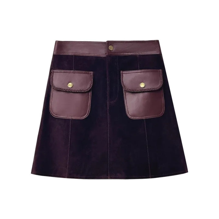 Dark purple suede lapel skirt with waistband, gold snaps, and two front patch pockets.