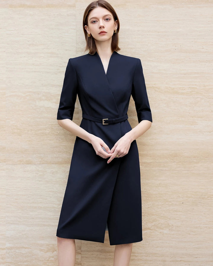 Knee-length navy skirt suit dress with V-neck and waist belt detail at center