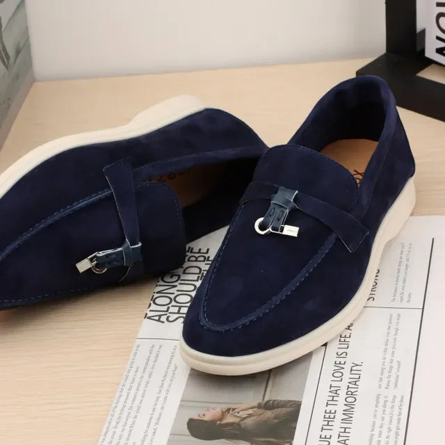 Navy suede slip-on loafers with metal bit detail and white rubber sole