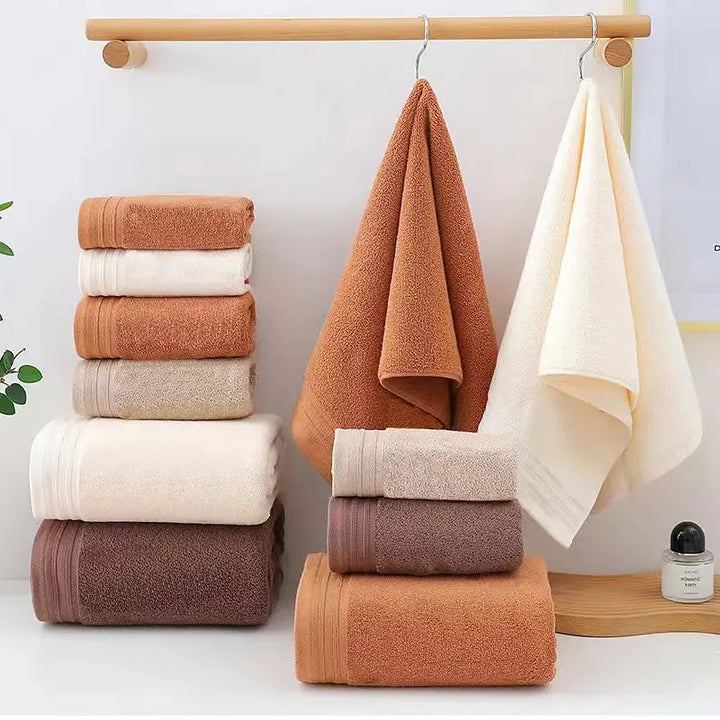 Cotton towel set with terracotta and cream rolled towels hanging and stacked