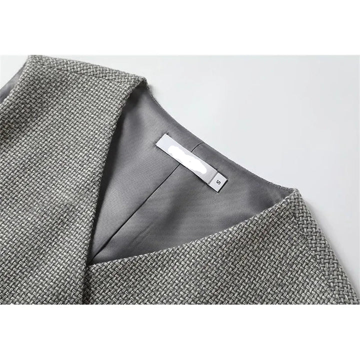 Grey sleeveless waistcoat inside neckline label with smooth lining and textured outer