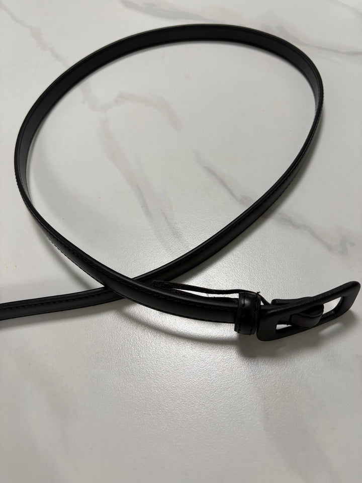 Black narrow leather belt with buckle and loop, flat end visible