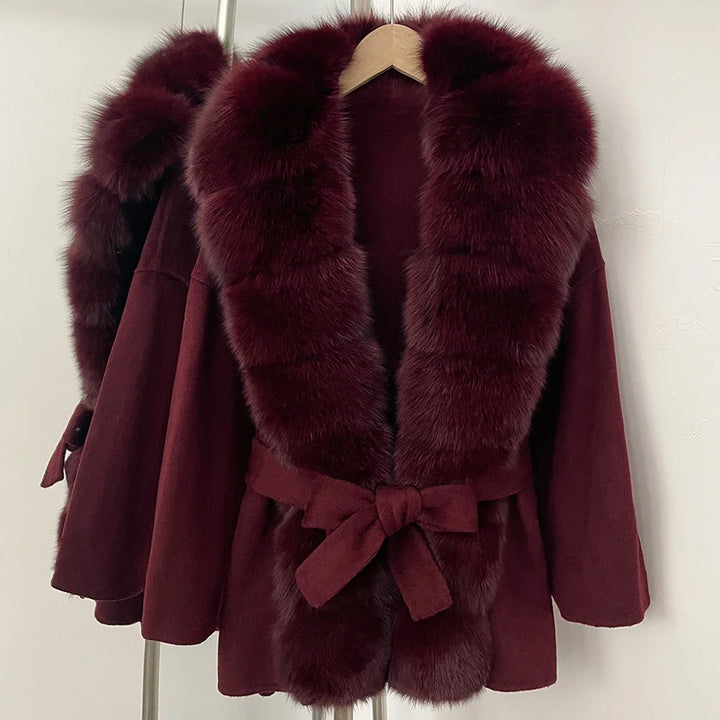 Wine red coat with faux fur front panels, wide lapels, and bow tie waist belt