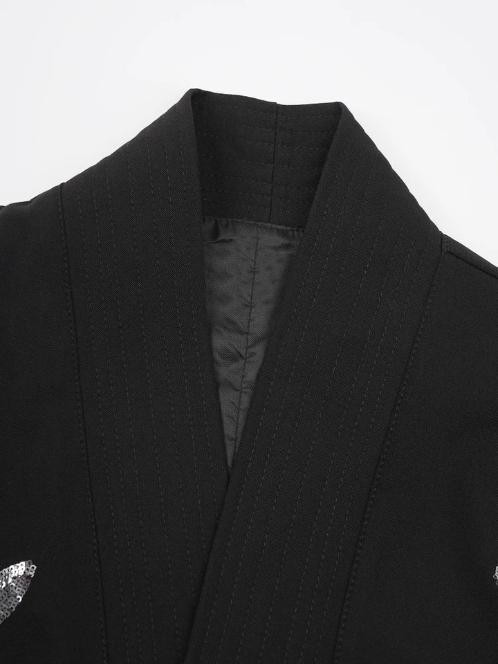 Black vest with structured collar and textured front panel detail
