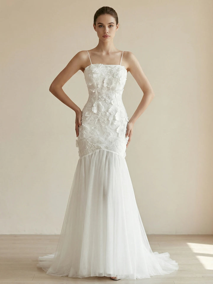 White bridal gown with applique bodice and sheer tulle skirt