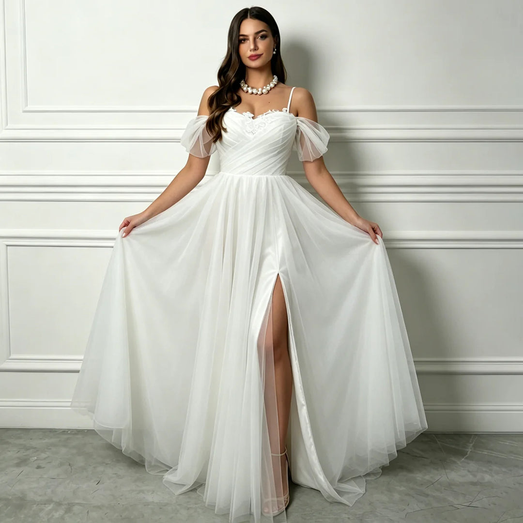 White A-line tulle bridal gown with beaded sweetheart bodice, flowing skirt, front slit