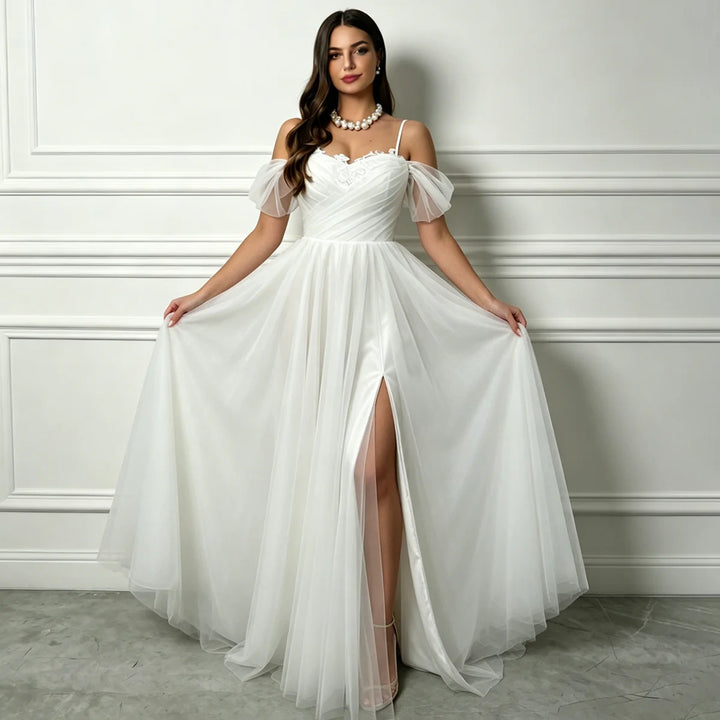 White A-line tulle bridal gown with beaded sweetheart bodice, flowing skirt, front slit