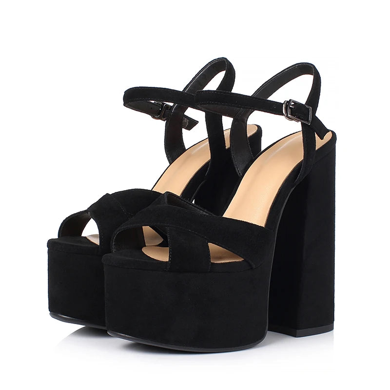 Black suede platform heeled sandals with cross straps and buckle ankle closure