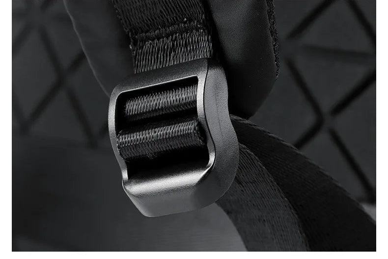 Black rucksack adjusting buckle on shoulder strap attachment