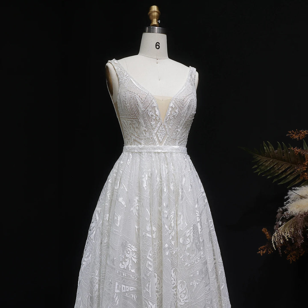 Off-white bridal gown on mannequin with V-neck embroidered bodice and full gathered skirt