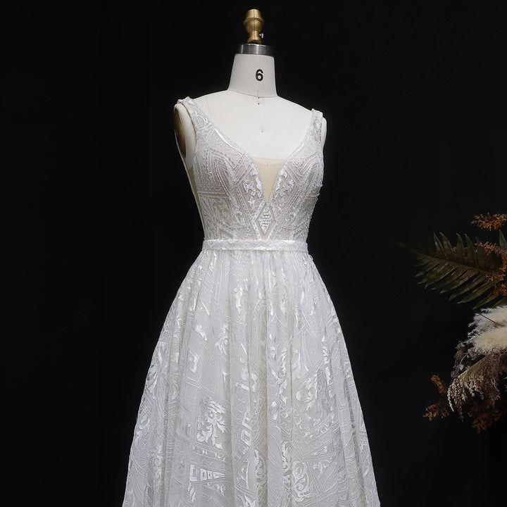 Off-white bridal gown on mannequin with V-neck embroidered bodice and full gathered skirt