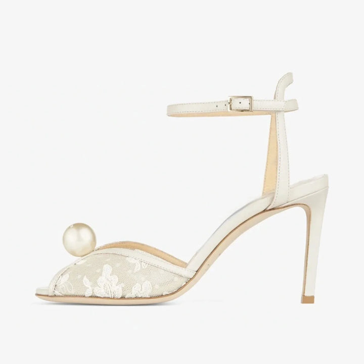 White peep-toe high heel sandal with ankle strap and lace inlay with pearl accent