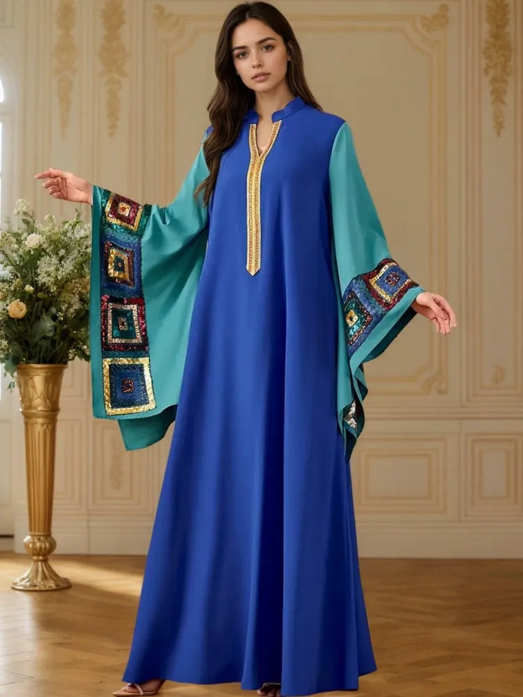 Blue abaya dress with batwing sleeves, turquoise panel accents, gold-trim tassel neckline
