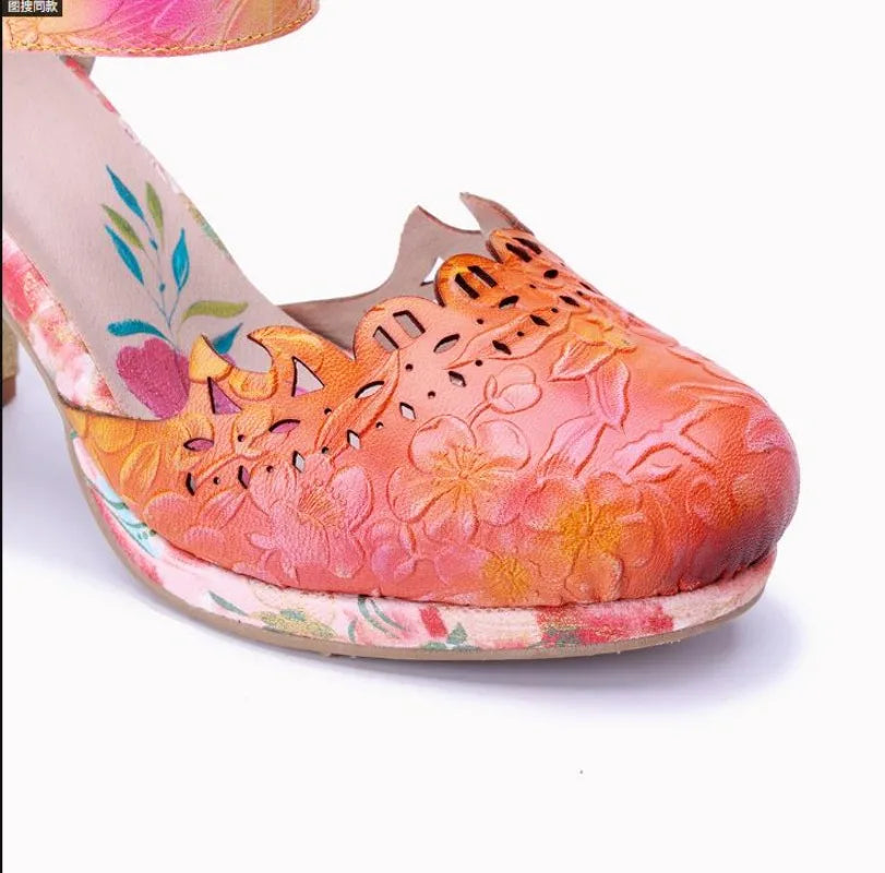Close-up of floral leather sandal with orange/pink upper and cutout toe detail