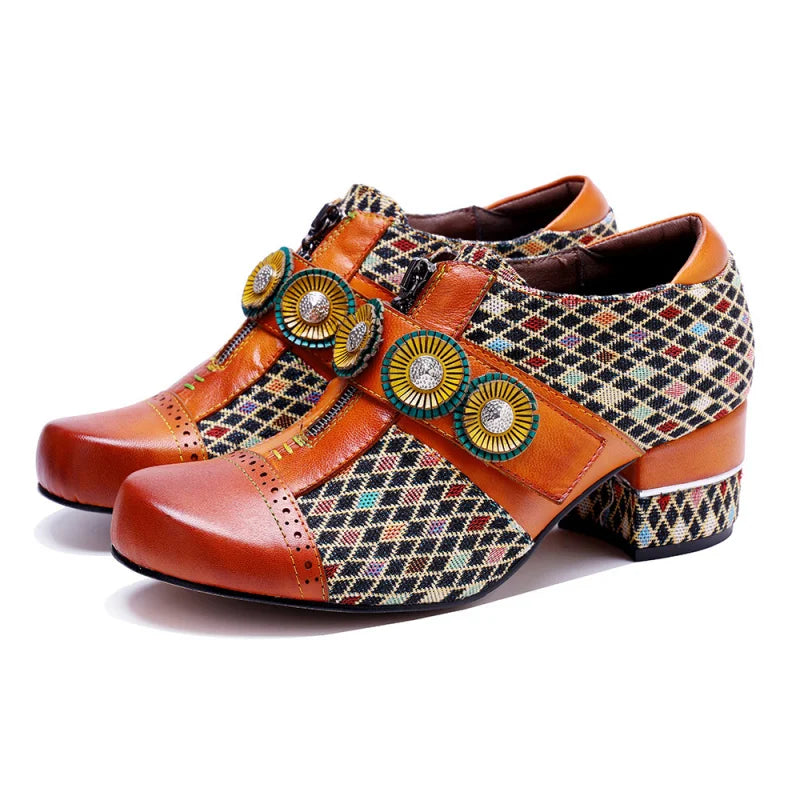 Front view of orange leather slingback dress shoes with patterned fabric and circular medallions