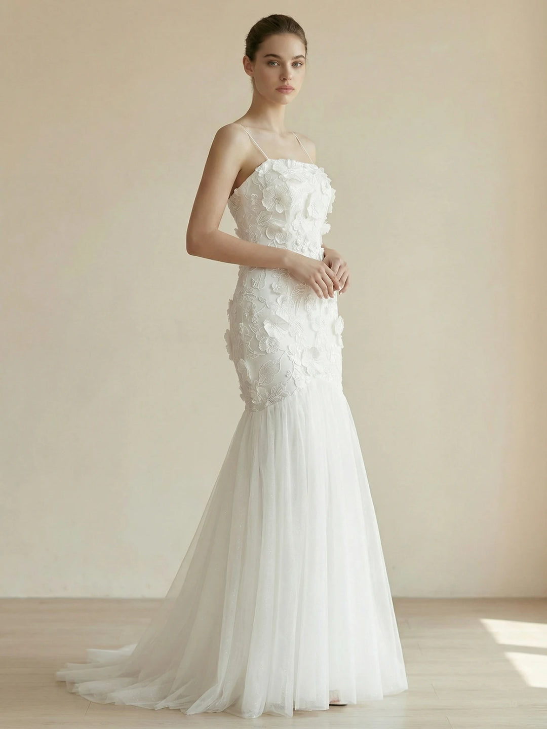 White appliqué bodycon bridal gown with spaghetti straps and sheer flared skirt
