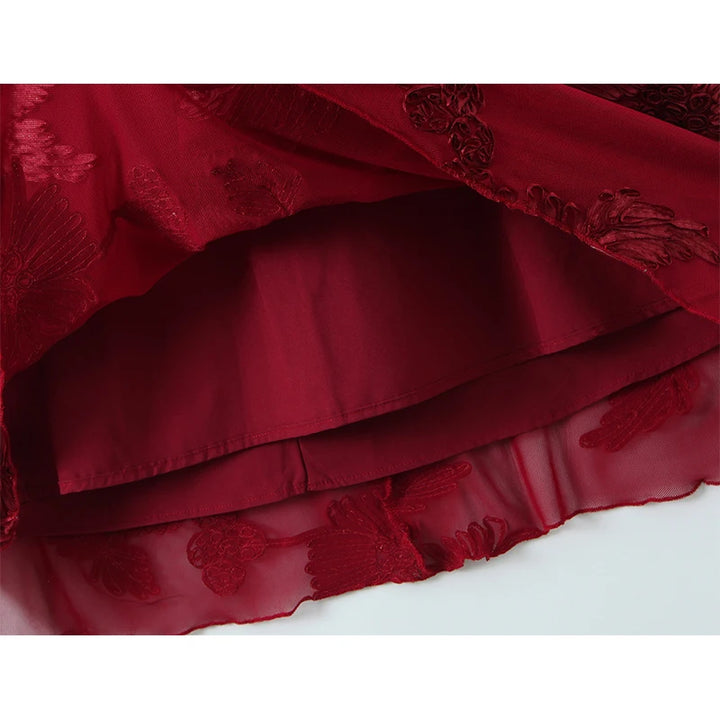 Red maxi dress hem with layered ruffle and floral lace texture