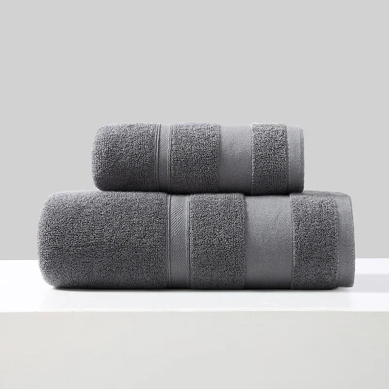 2-piece cotton towel set in dark gray, rolled and folded with stitched bands