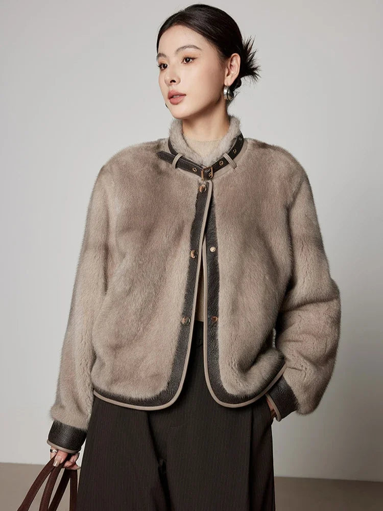 Light gray women's short mink fur coat with button front and dark-trimmed hem